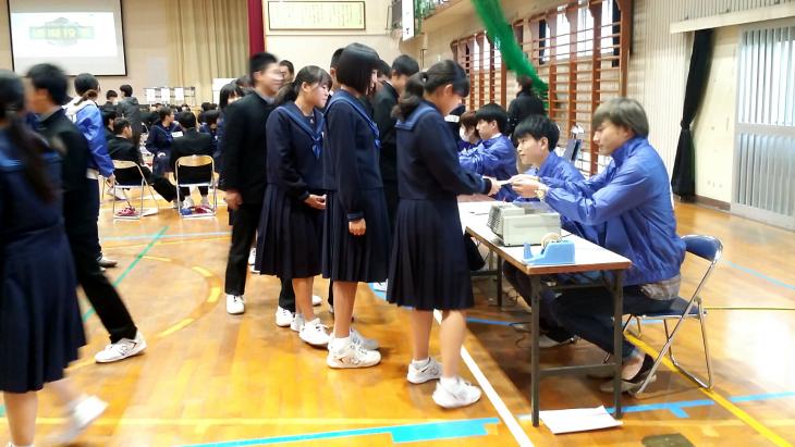 投票用紙の交付を受ける学生